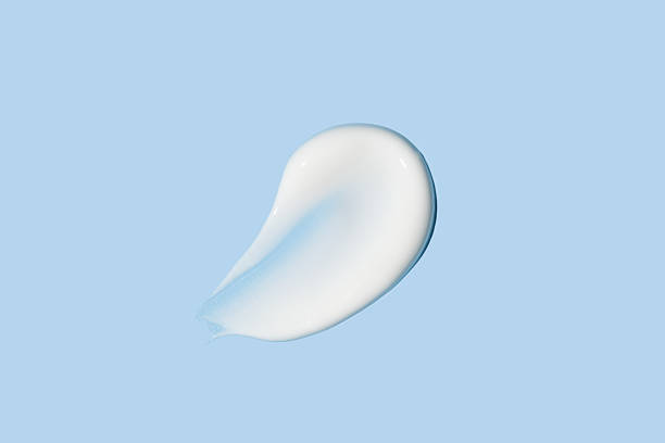 istock Cosmetic product smear white moisturizing lotion isolated on blue, squeezed out and smeared portion of skincare cream product testing. 2234146359