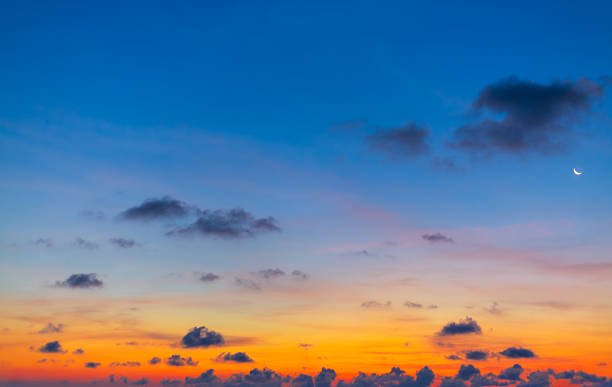 istock Morning clouds and sky with crescent moon,Gentle evening landscape: crescent moon against a blue sky with pink clouds at sunset 2234146523