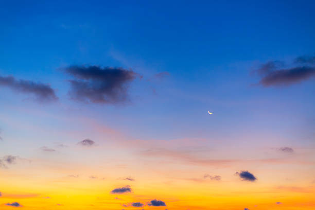 istock Morning clouds and sky with crescent moon,Gentle evening landscape: crescent moon against a blue sky with pink clouds at sunset 2234146540