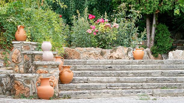 Charming staircase adorned with vibrant green plants and blooming flowers in Santa Cruz, Alicante. A picturesque scene showcasing Mediterranean beauty and tranquility.