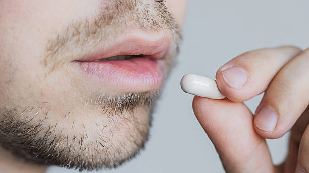 istock Take medicines. Put pill in mouth 2234146701