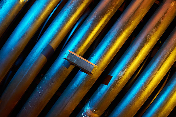 istock Metal ingot resting on industrial pipes with dramatic lighting 2234148822