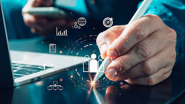 istock A professional uses a stylus on a digital interface to manage a business team, analyze strategy, and review data. This image represents modern team management, HR, communication, and organizational planning with technology. 2234149608