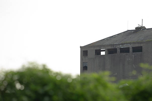 An Abandoned Building Standing Tall Against a Clear Blue Sky