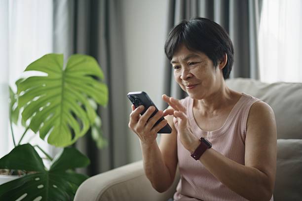 istock Mature woman using smartphone at home. 2234153894
