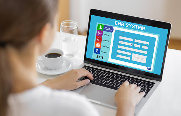 istock Woman Using Laptop with EHR System Interface on Screen for Digital Health Data Entry 2234154350