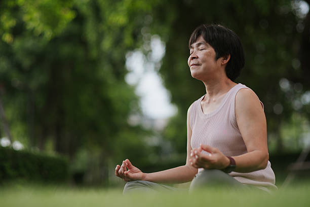 istock Mature woman tracking mindfulness session outdoors. 2234154449
