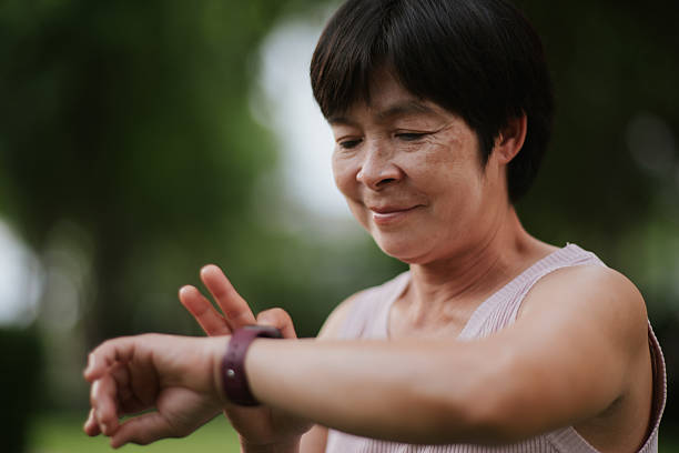 istock Mature woman using smartwatch at park. 2234154457