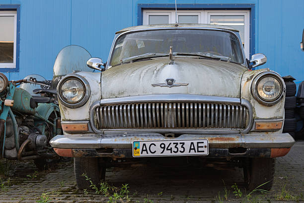 Wroclaw, Poland - August 28 2025: Moss-covered front of Soviet GAZ Volga with Ukrainian plate