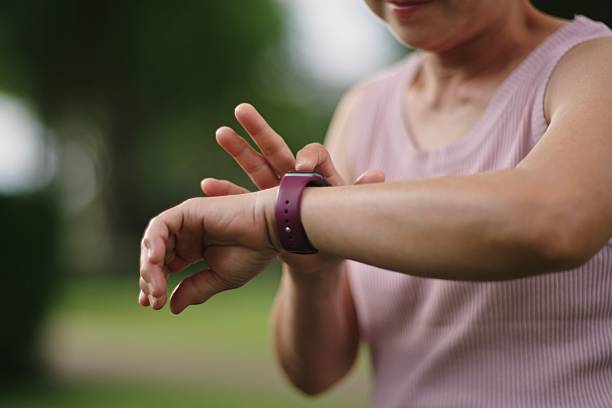 istock Mature woman using smartwatch at park. 2234155474