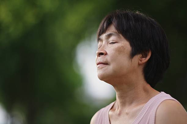 istock Mature woman tracking mindfulness session outdoors. 2234155477