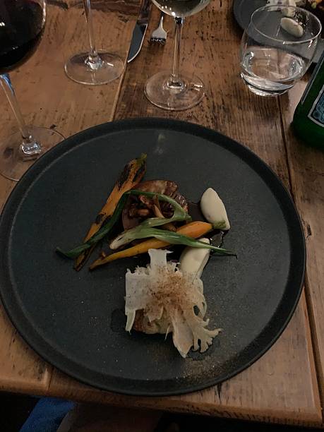 istock Gourmet Fine Dining Meal with Wine on a Rustic Wooden Table 2234157924