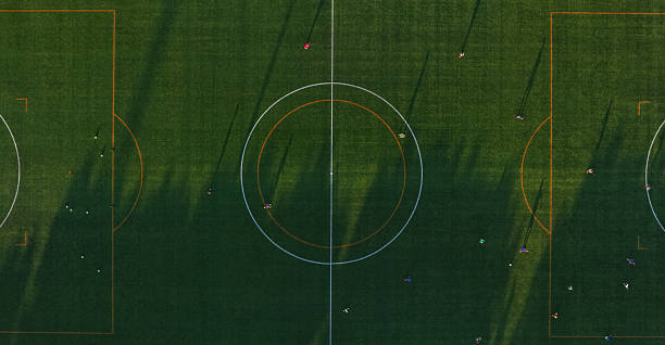 istock Soccer field from above with team playing at sunset 2234159755