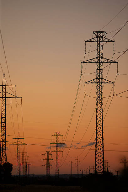istock Power Lines Silhouetted Against a Beautiful Sunset 2234161331