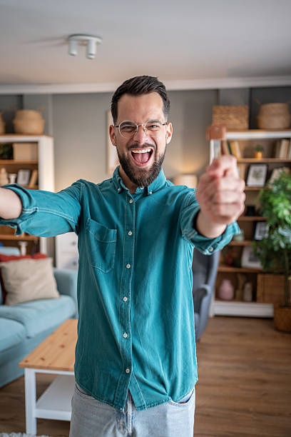 istock Excited young man celebrating success at home 2234164604