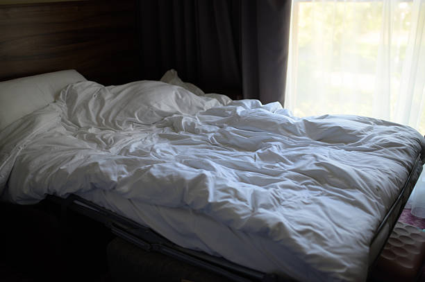 istock A rumpled white bed covers in a softly lit room showcase a serene morning atmosphere, inviting relaxation and comfort 2234172047