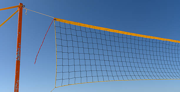 istock A brightly colored volleyball net is set up at a beach, framed by a clear blue sky on a sunny day, ready for players to enjoy 2234172824
