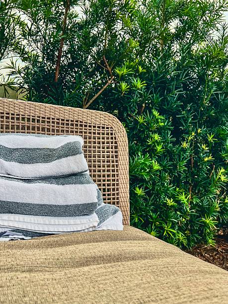 istock Lounge chair by pool with towels 2234174830