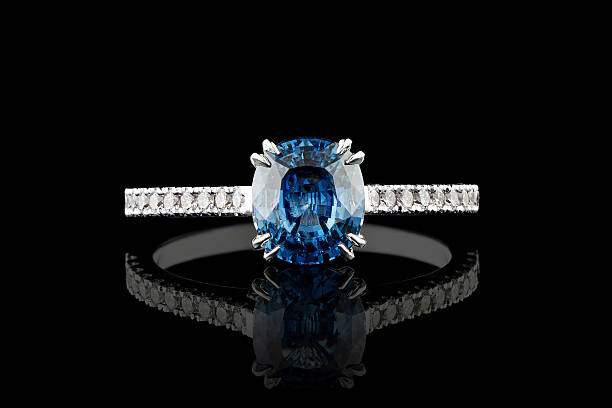 istock white metal ring, silver, gold with sapphire stone, diamonds on black background 2234177281