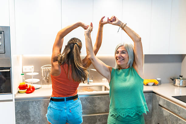 istock Mother and daughter dancing together in the kitchen 2234184192