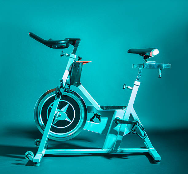 close up asian woman legs keep exercising by riding on home bike