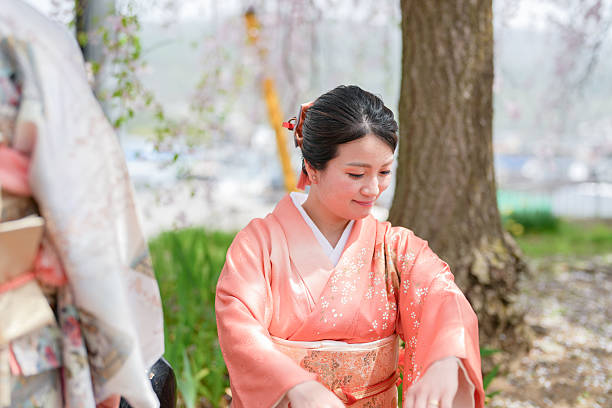 istock A woman in a traditional Japanese kimono sits under a tree 2234185911
