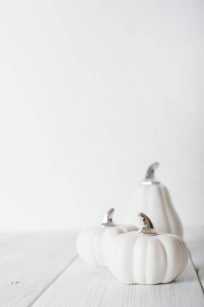 istock Minimalist White Pumpkins on White Wooden Background 2234190872
