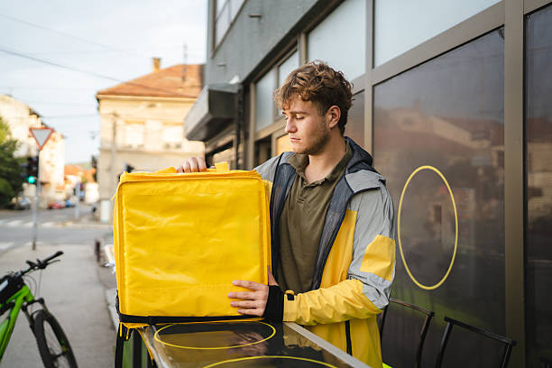 istock Delivery man picking up food order at restaurant with thermal backpack 2234194876