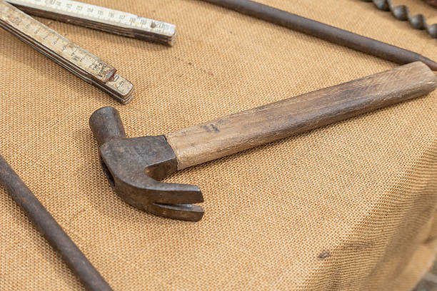 istock Old hammer and carpenter's tools resting on burlap 2234197983