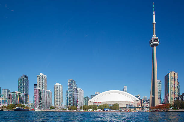 The Rogers Centre Hockey stadium, the CN Tower Toronto skyscraper high building, and the skyline. Ontario Lake, Ontario, Canada