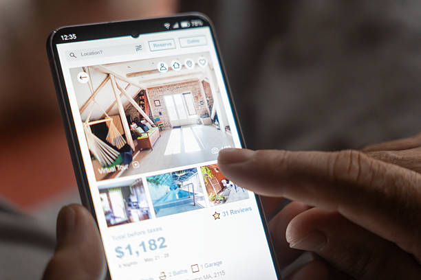 istock Man uses phone to explore homes for sale 2234202424