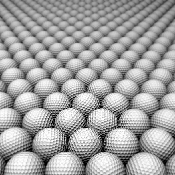 Fore! Or maybe not? Cracked and destroyed golf ball in the dirt. Still white but dirt is situated in the dimples. It's almost other-worldly like a planet!