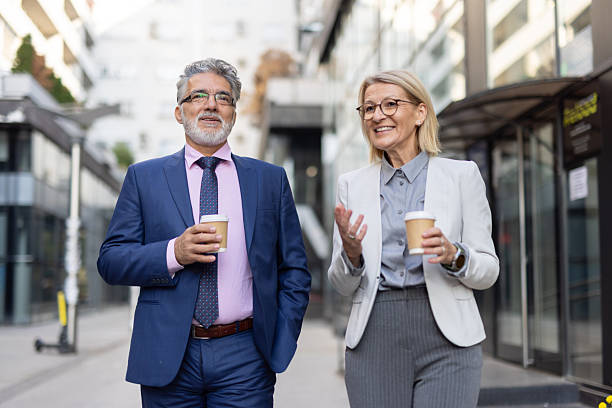 istock Happy professionals engage in wide-smile street talks 2234209101