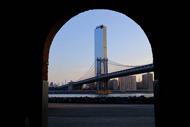 istock Manhattan Bridge and East River Framed by Arch at Sunrise (Brooklyn, New York, USA) 2234216444