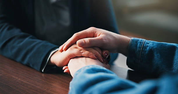 istock Holding hands, table and couple in home for empathy, support and bonding for love. Relationship, counseling and above of people together for connection, affection and care for commitment in house 2234216623
