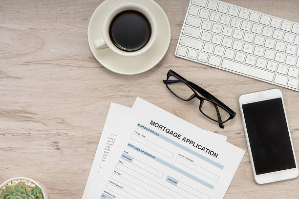 istock Mortgage application form on wooden table. 2234224159