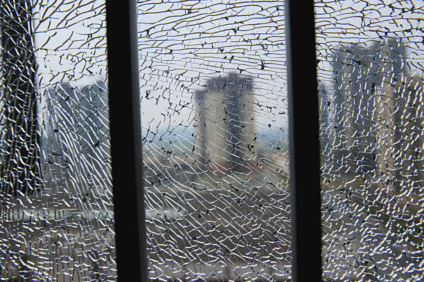 Cracks in the glass on colorful background, failure and problems symbol, shattered glass, broken glass with cracks