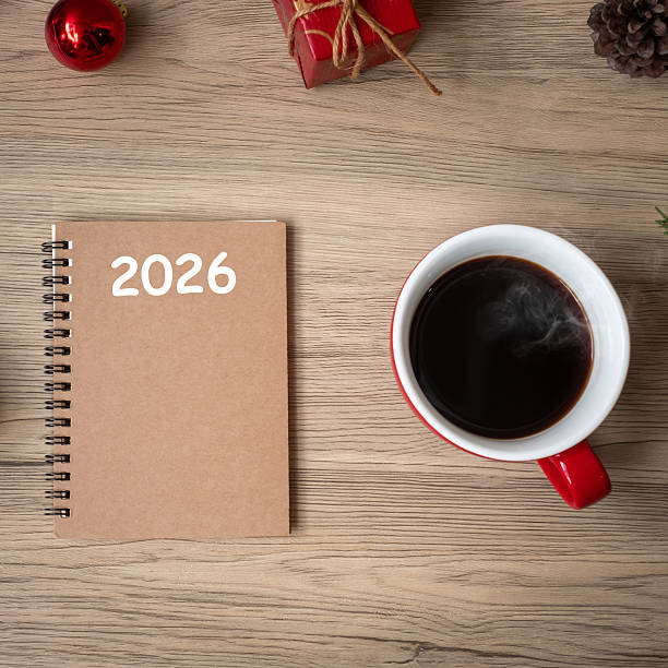 istock 2026 notebook, black coffee cup and Christmas gift on wood table, Top view and copy space. Xmas, Happy New Year, Goals, Resolution, To do list, Strategy and Plan concept 2234230153