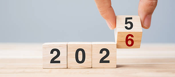 istock hand flip cube block 2025 to 2026 text on table. Resolution, review, strategy, end year, goal, business and New Year holiday concepts 2234230159