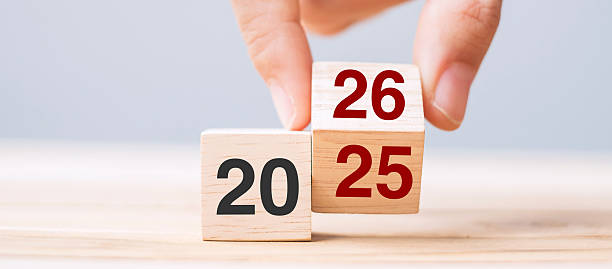 istock hand flip cube block 2025 to 2026 text on table. Resolution, review, strategy, end year, goal, business and New Year holiday concepts 2234230212