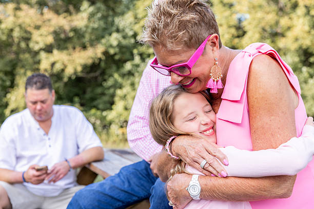 Grandmother and granddaughter embracing at home