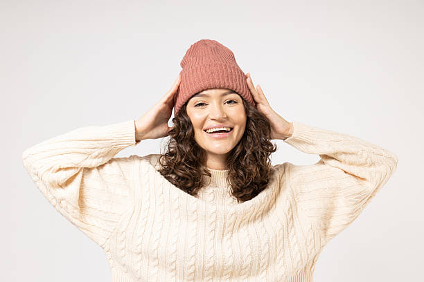 istock A woman in white knitted clothes on a light background. 2234231972