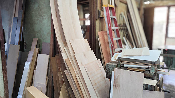 istock Small Wood Factory Yard with Stacked Lumber and Complete Workshop Setup 2234232367