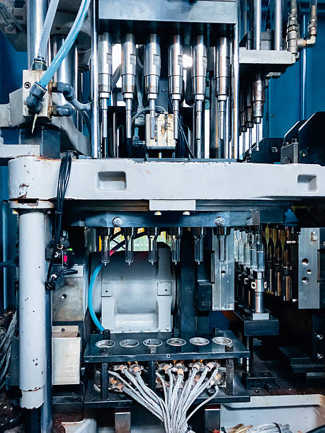 istock Blow molding machine producing clear plastic bottles on factory production line. 2234232714