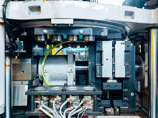 istock Blow molding machine producing clear plastic bottles on factory production line. 2234232719