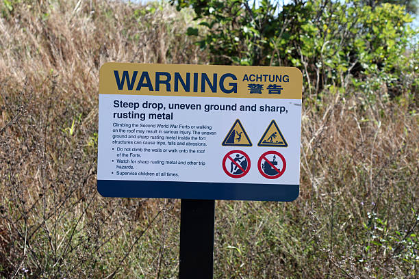 istock Warning sign for steep drop, uneven ground and sharp rusting metal in a rural environment 2234233853