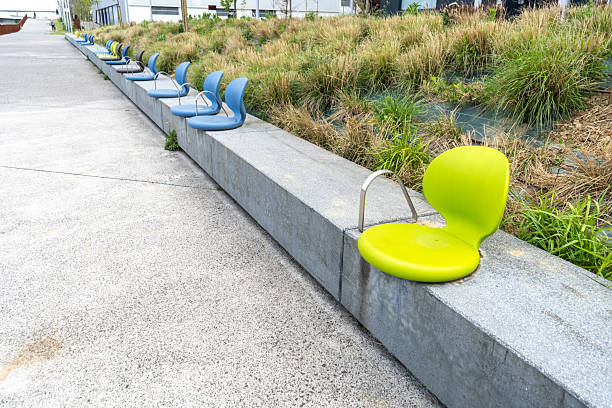 Stacked modern cafe chairs and tables of a closed sidewalk cafe during the second corona shutdown in autumn. (Germany)