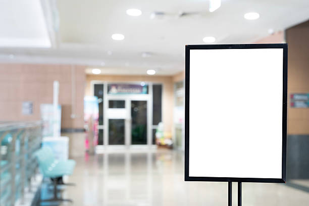 istock Blank signage mockup with black frame in hospital lobby, empty advertising display board template 2234235228