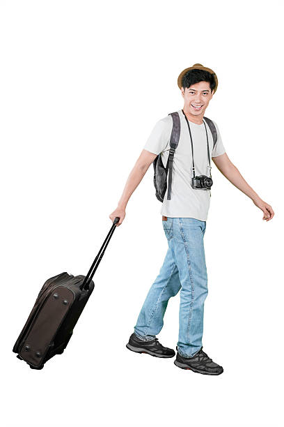 istock Happy Young Man Pulling a Suitcase and Ready to Travel 2234236899