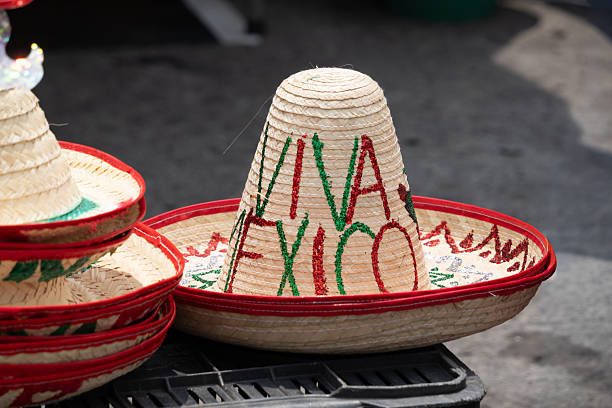 A red and green hat with the word viva mexico written on it. The hat is sitting on a table